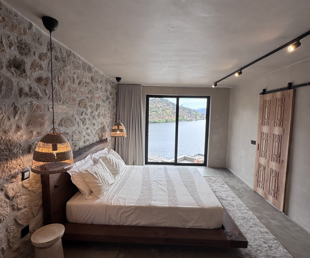 Bedroom with stone floor, river view