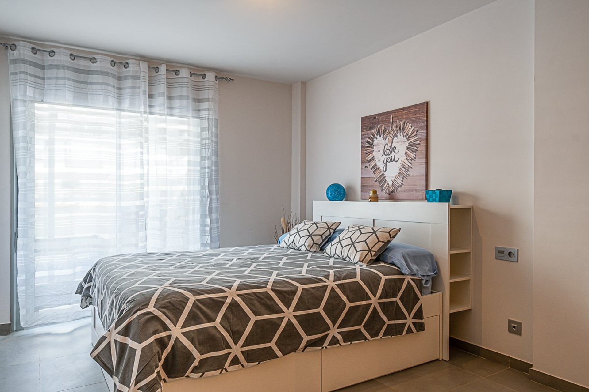 Bright master bedroom with curtains