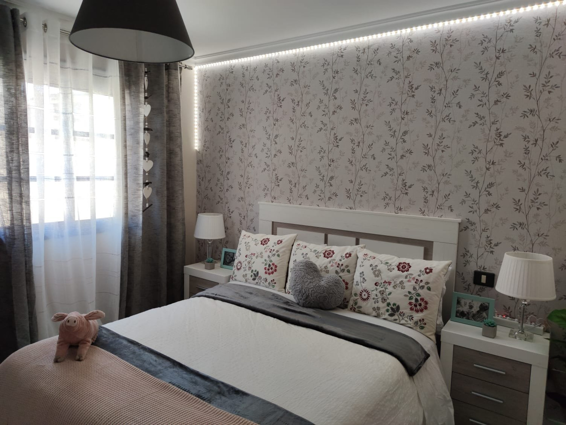 Cozy bedroom with floral wallpaper