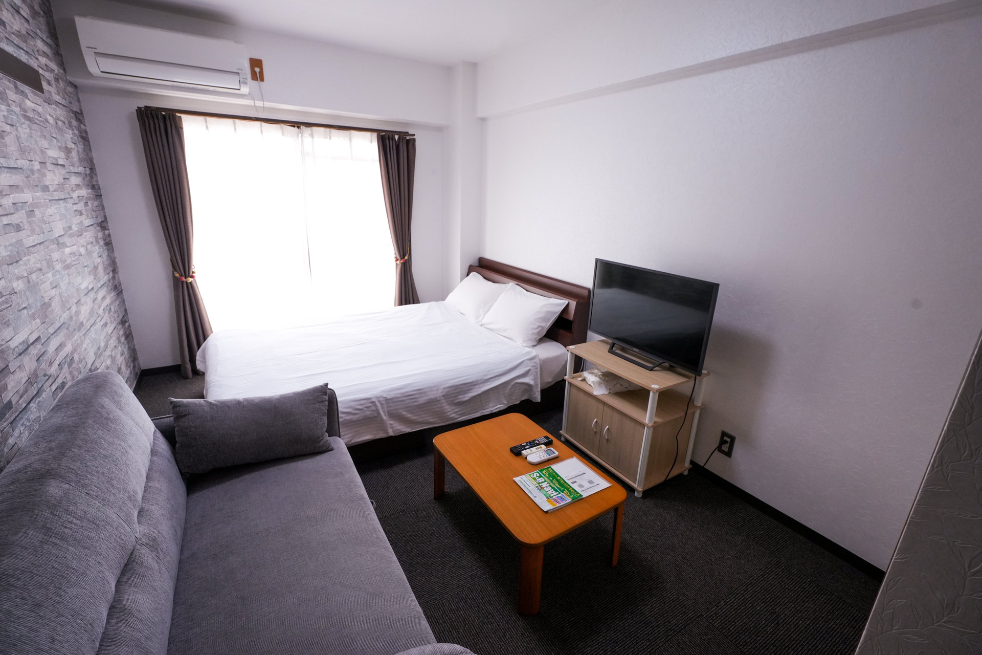 Bedroom with sofa and TV