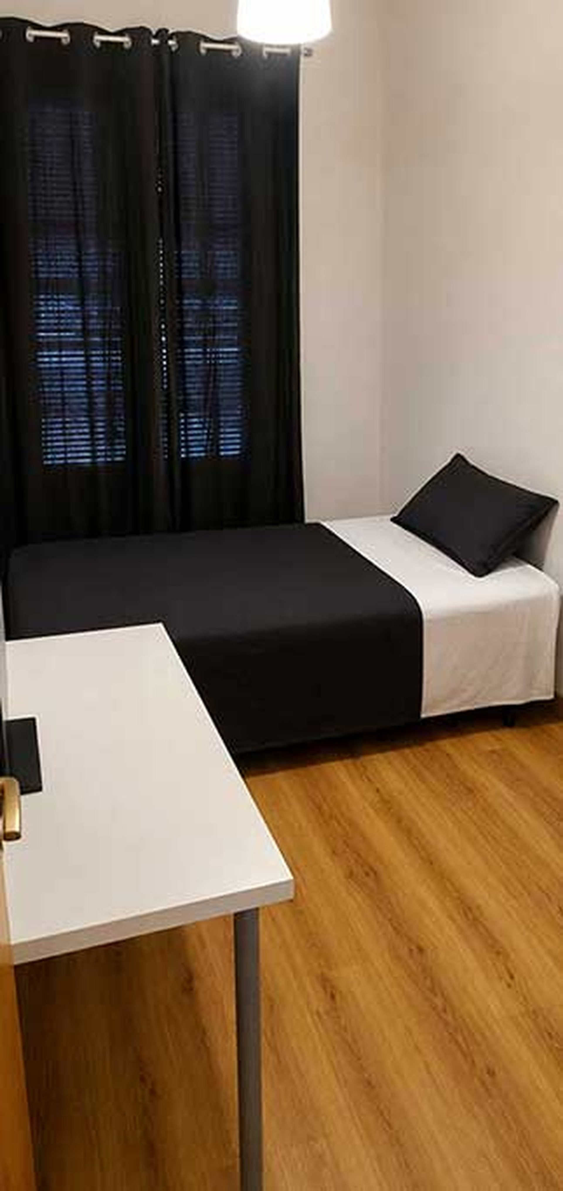 Bedroom with curtains and desk