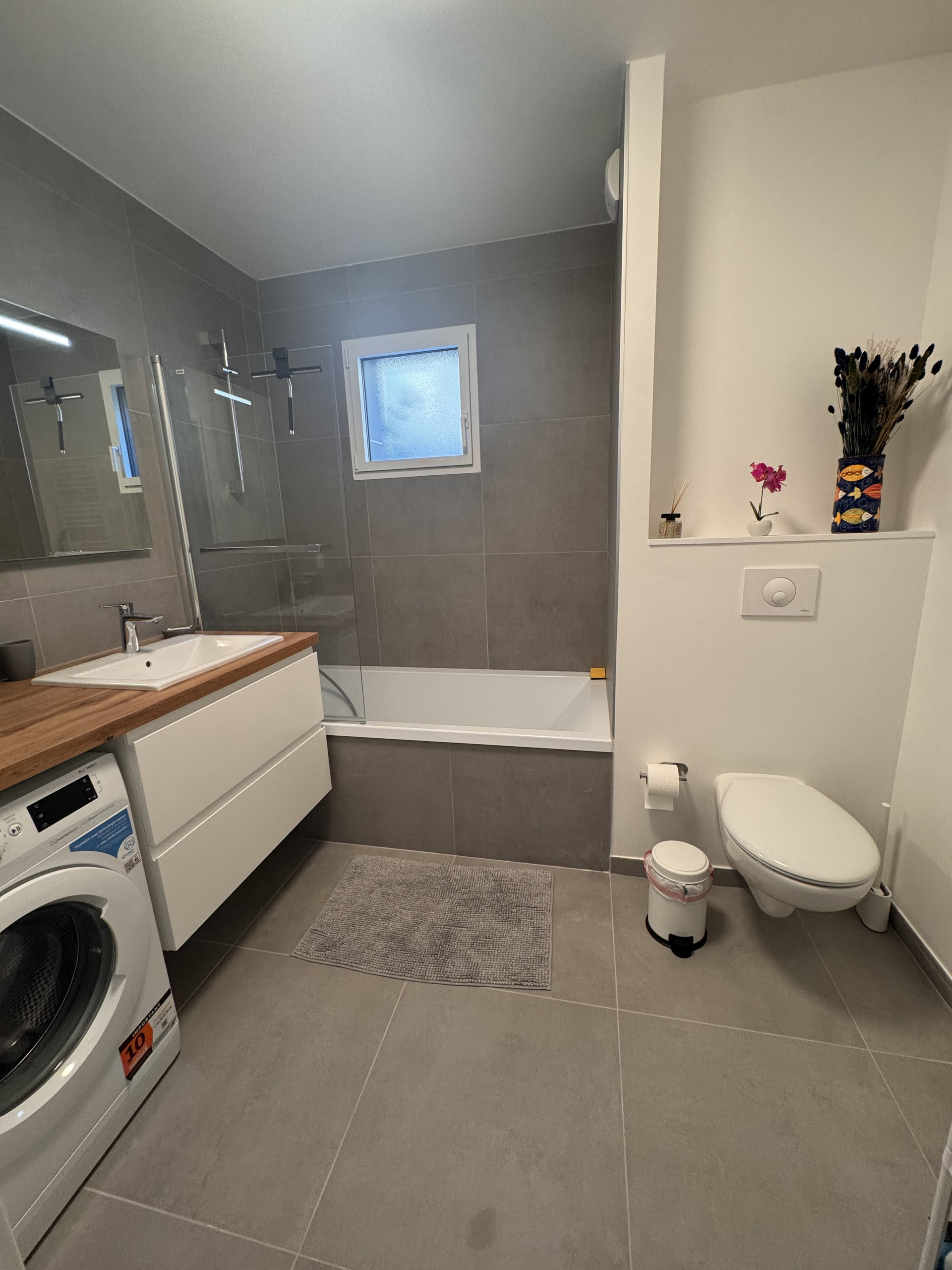 Bathroom with shower and washing machine