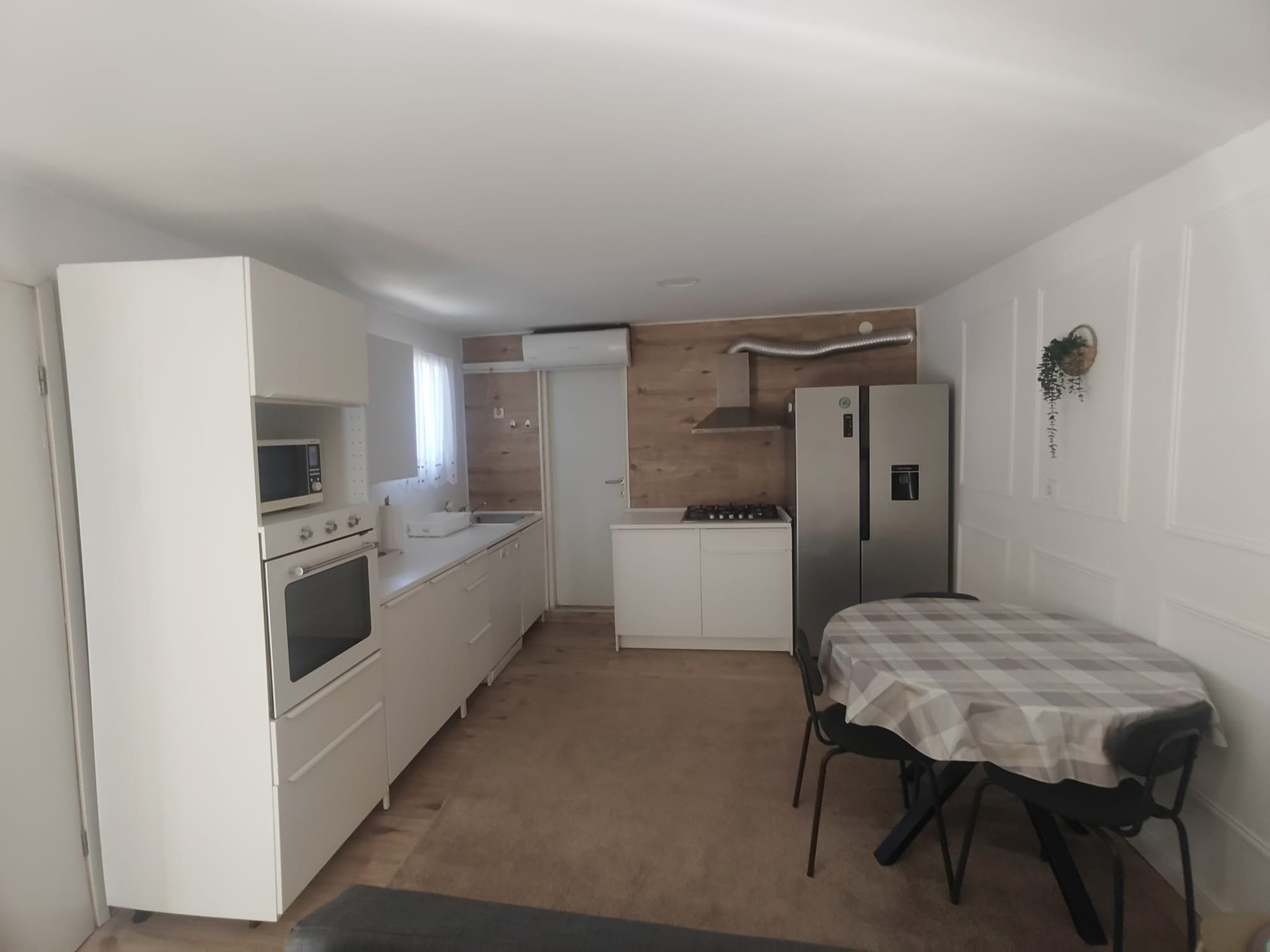 Kitchen with fridge and table