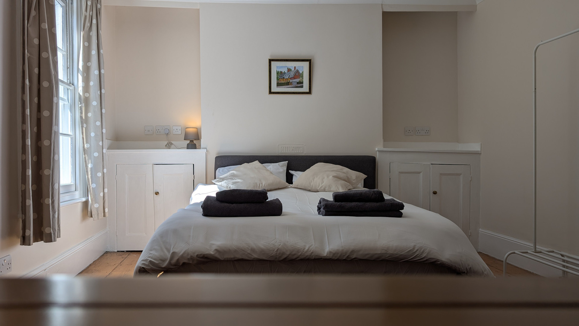 Bedroom with double bed and towels
