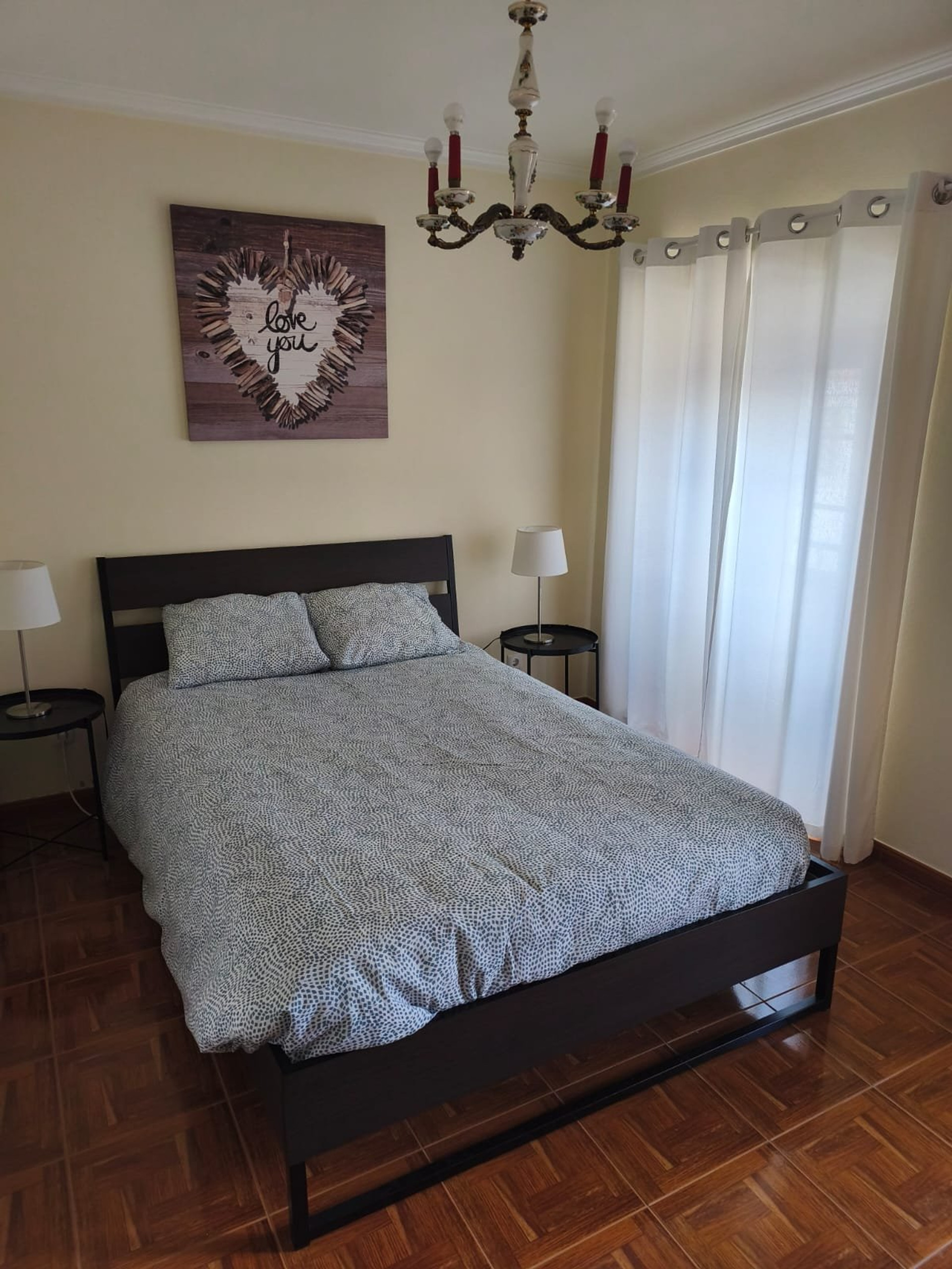 Bedroom with chandelier and double bed