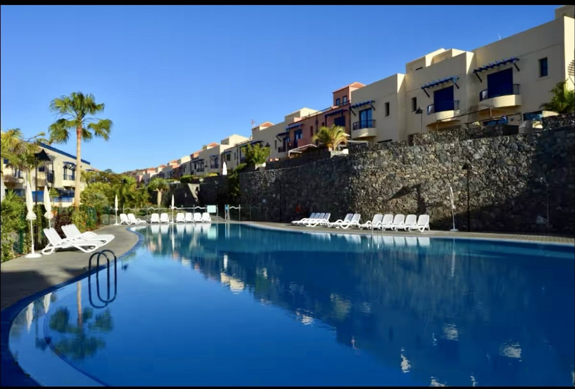 Large communal pool with loungers