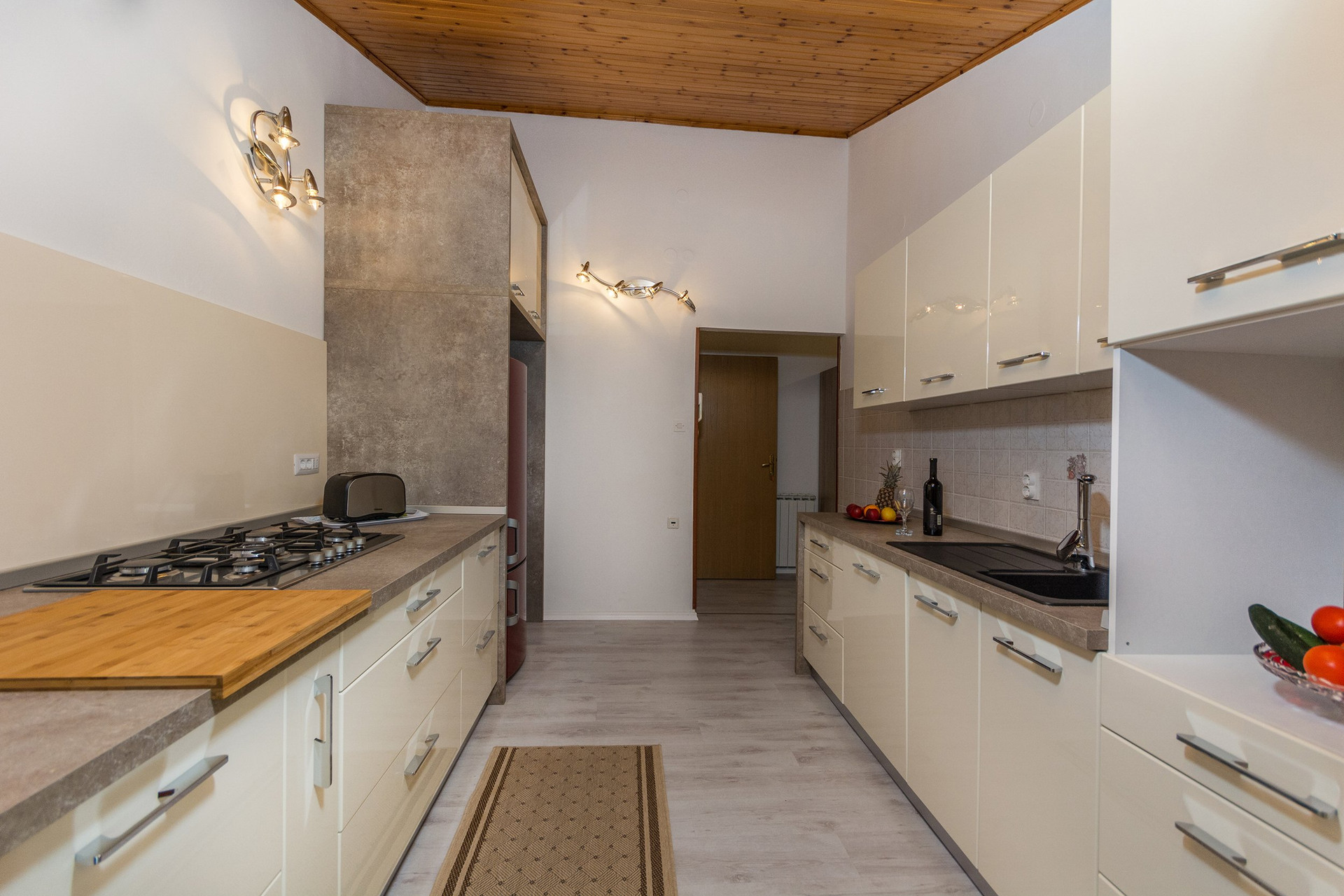 Spacious galley kitchen with wood ceiling