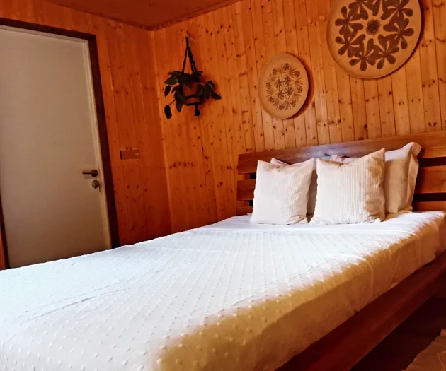 Wood-paneled bedroom with bed