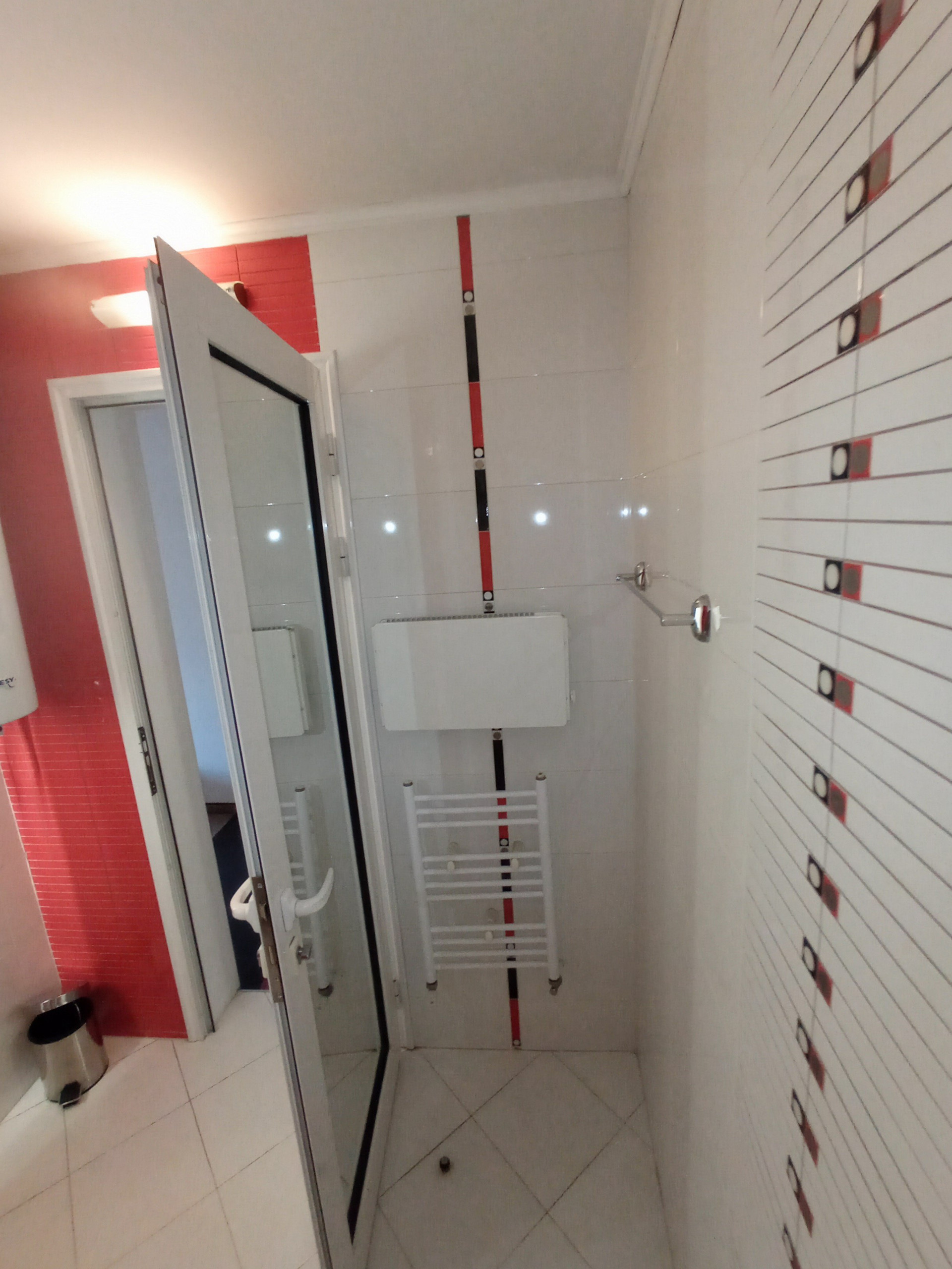Shower cabin and towel radiator