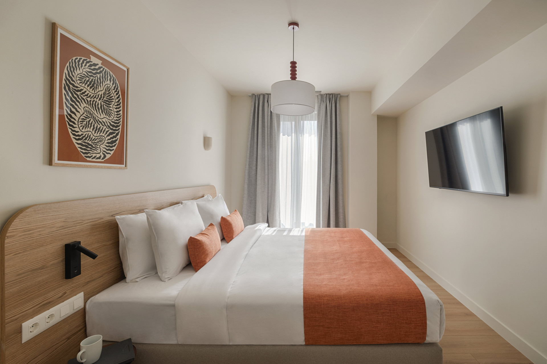 Bedroom with double bed orange accents