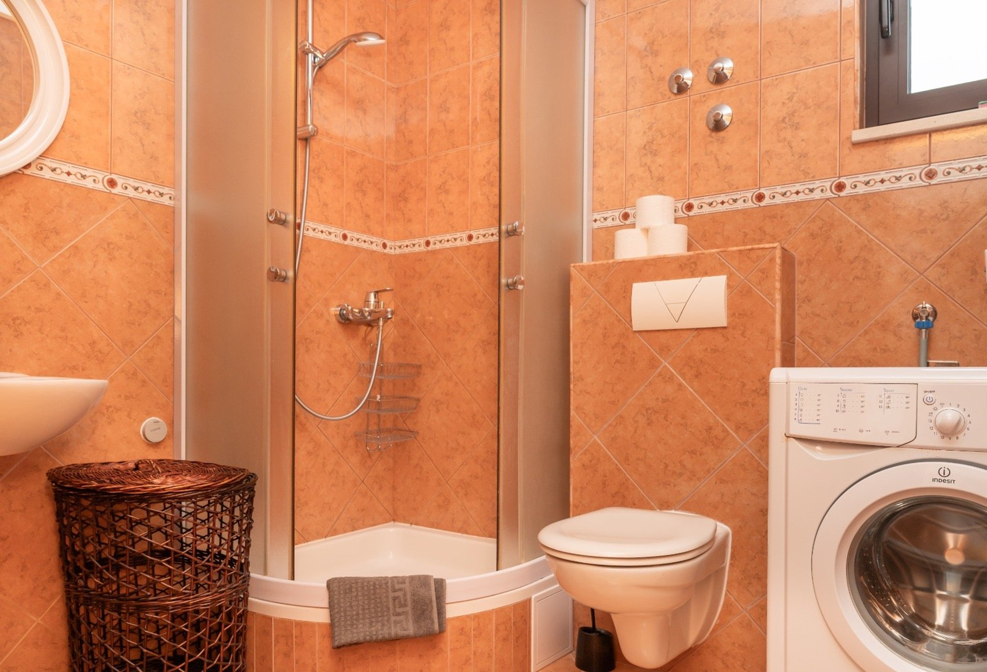 Bathroom with shower and washer