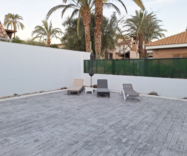 Empty patio with sun loungers