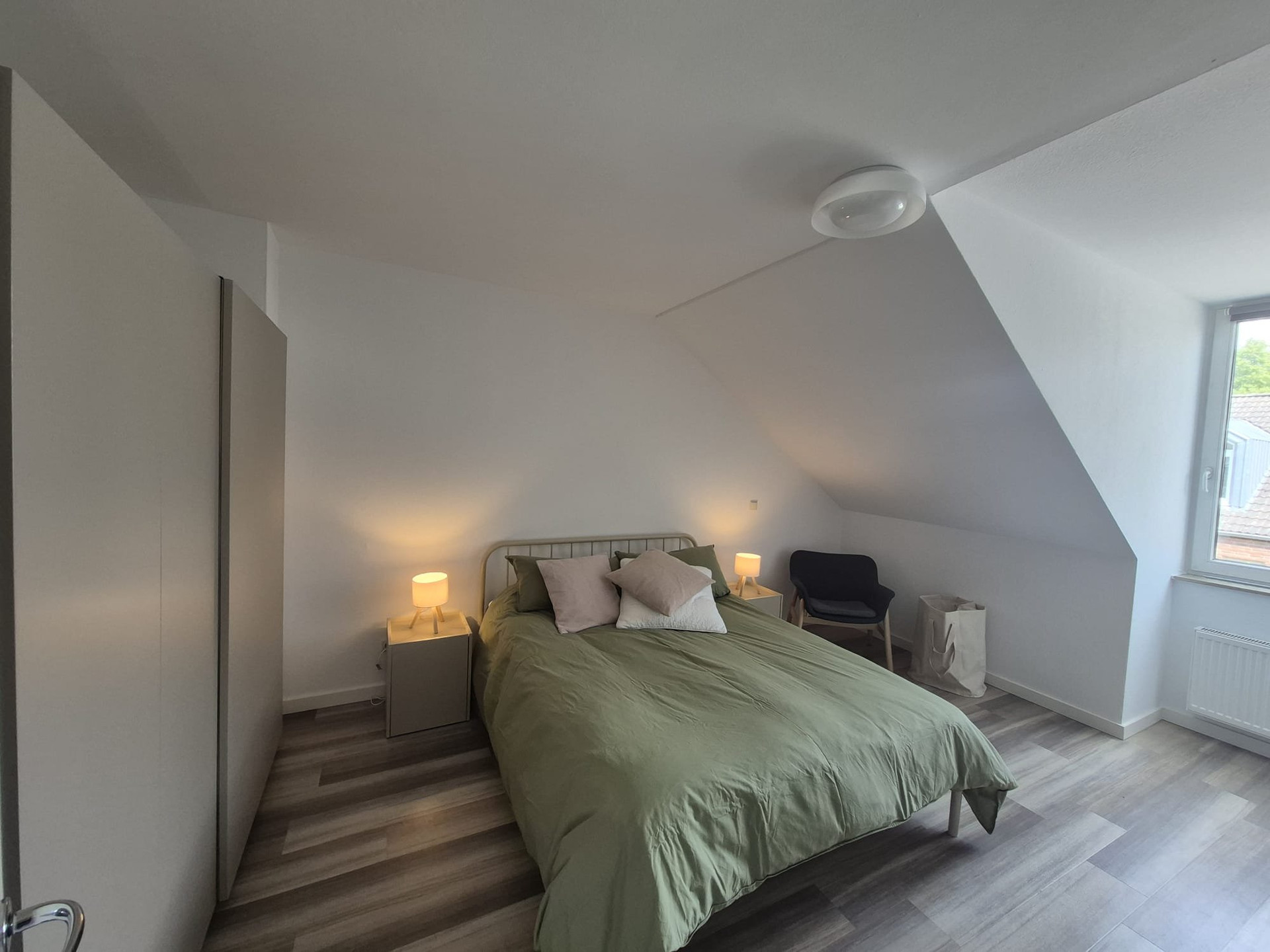 Bright bedroom with green bedding