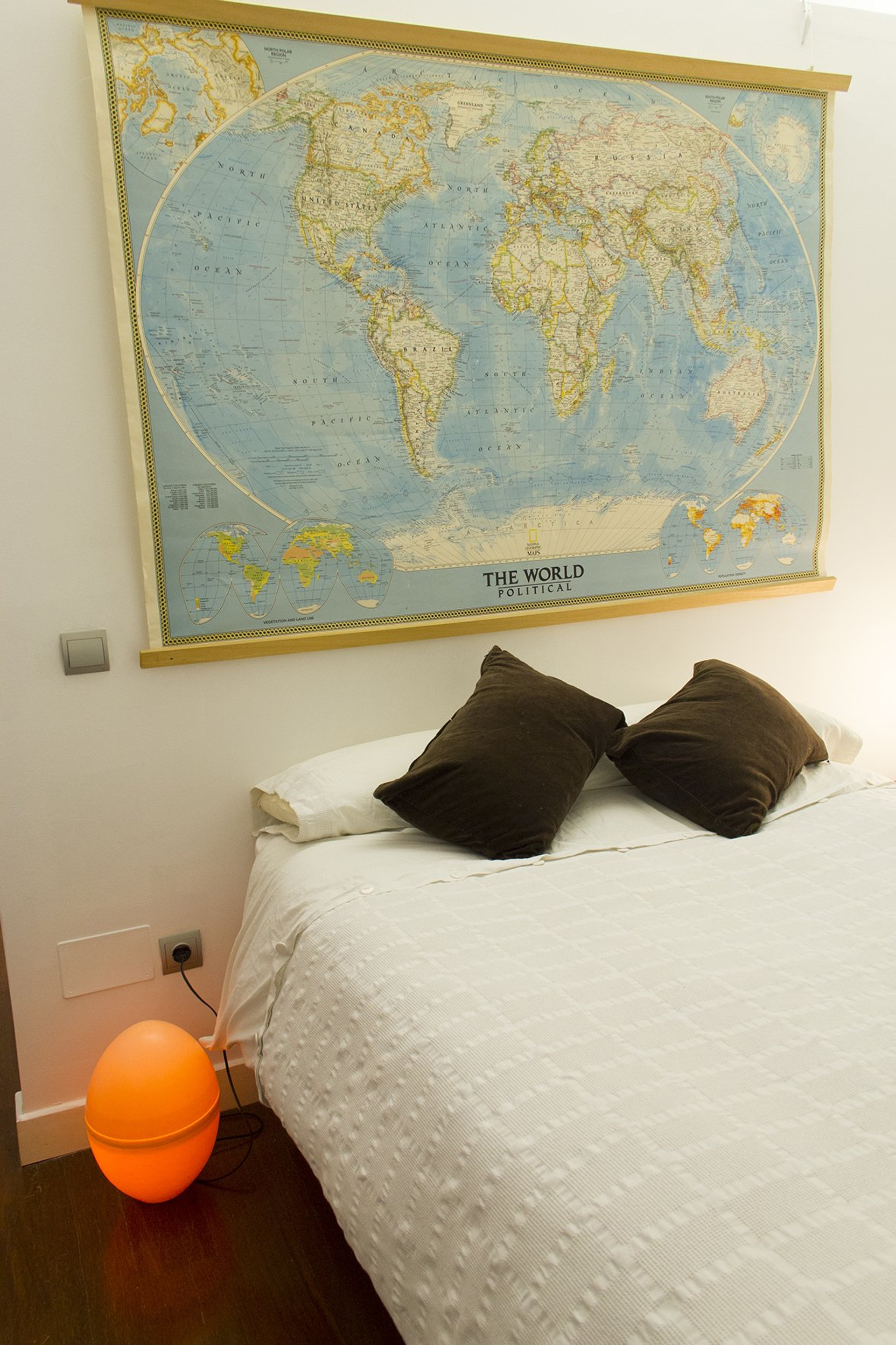 Bedroom with map and orange lamp
