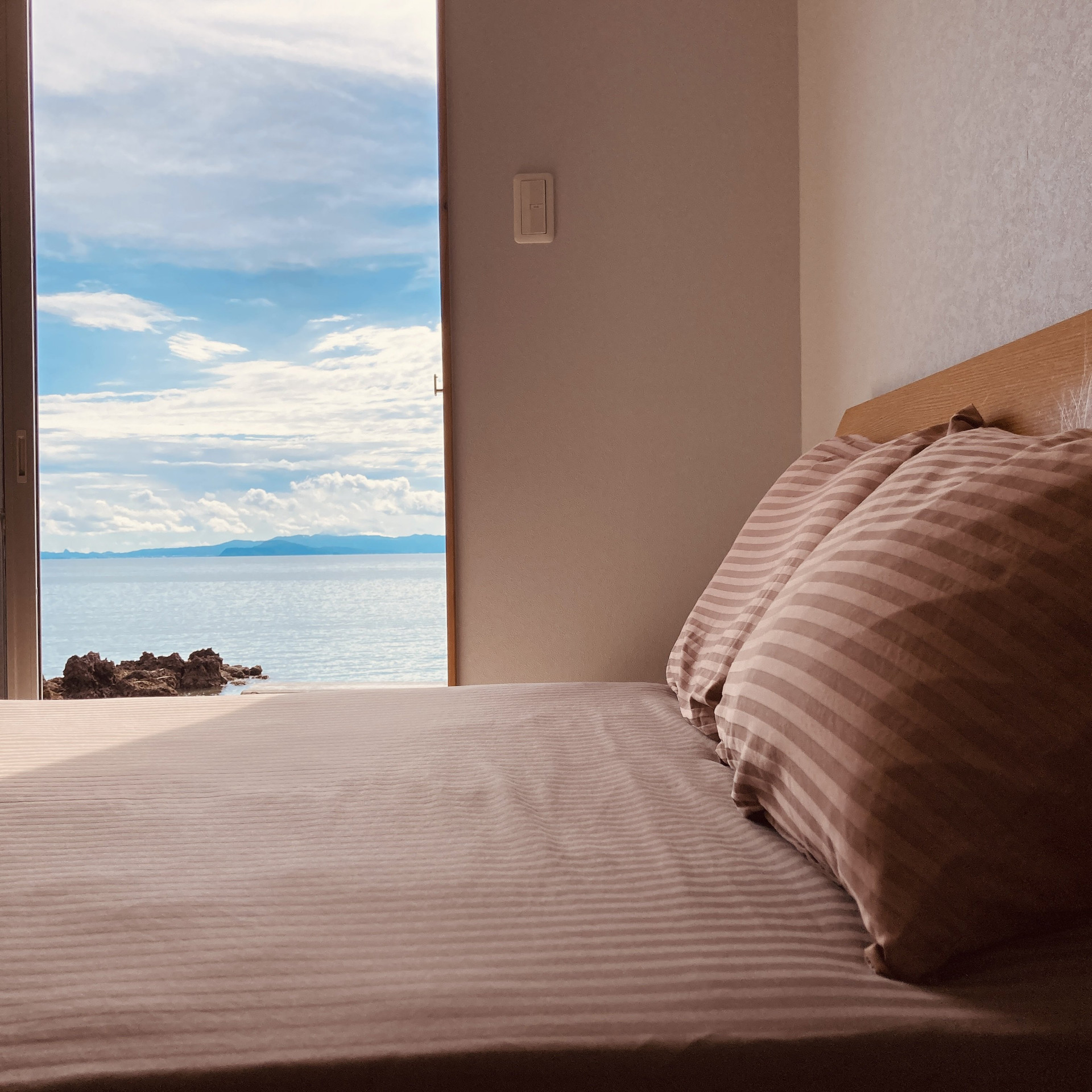 Bed with ocean view window