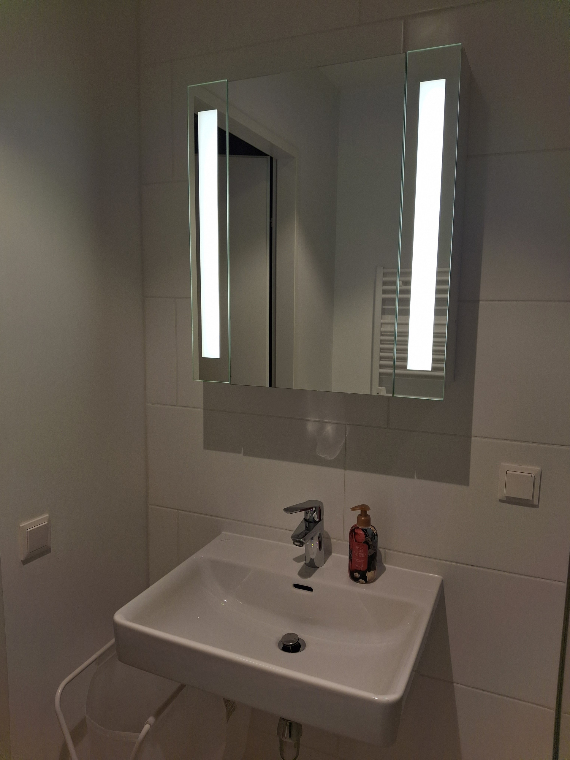 Bathroom sink with illuminated mirror