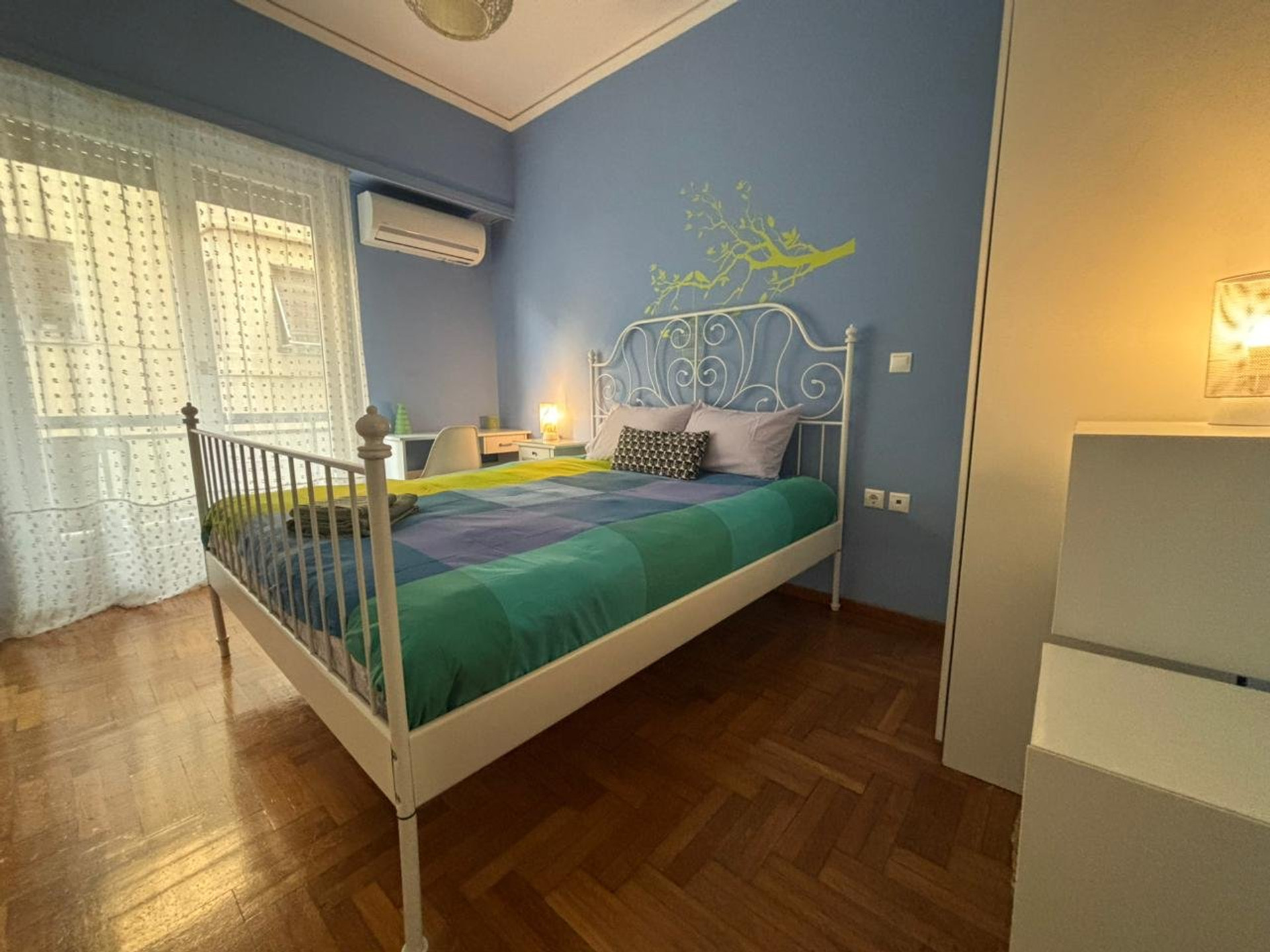 Blue bedroom with iron bed frame