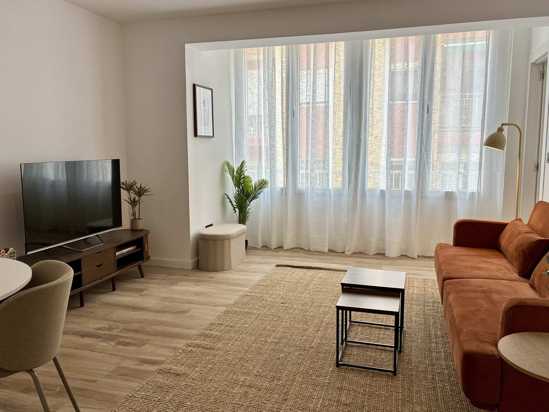 Bright living room with orange sofa