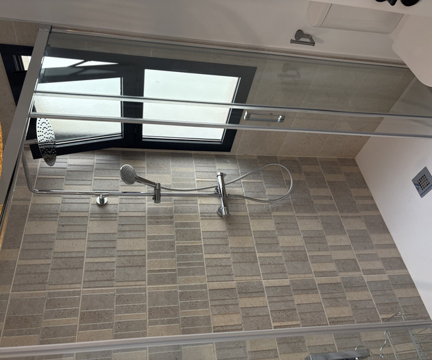 Modern shower with tiled walls