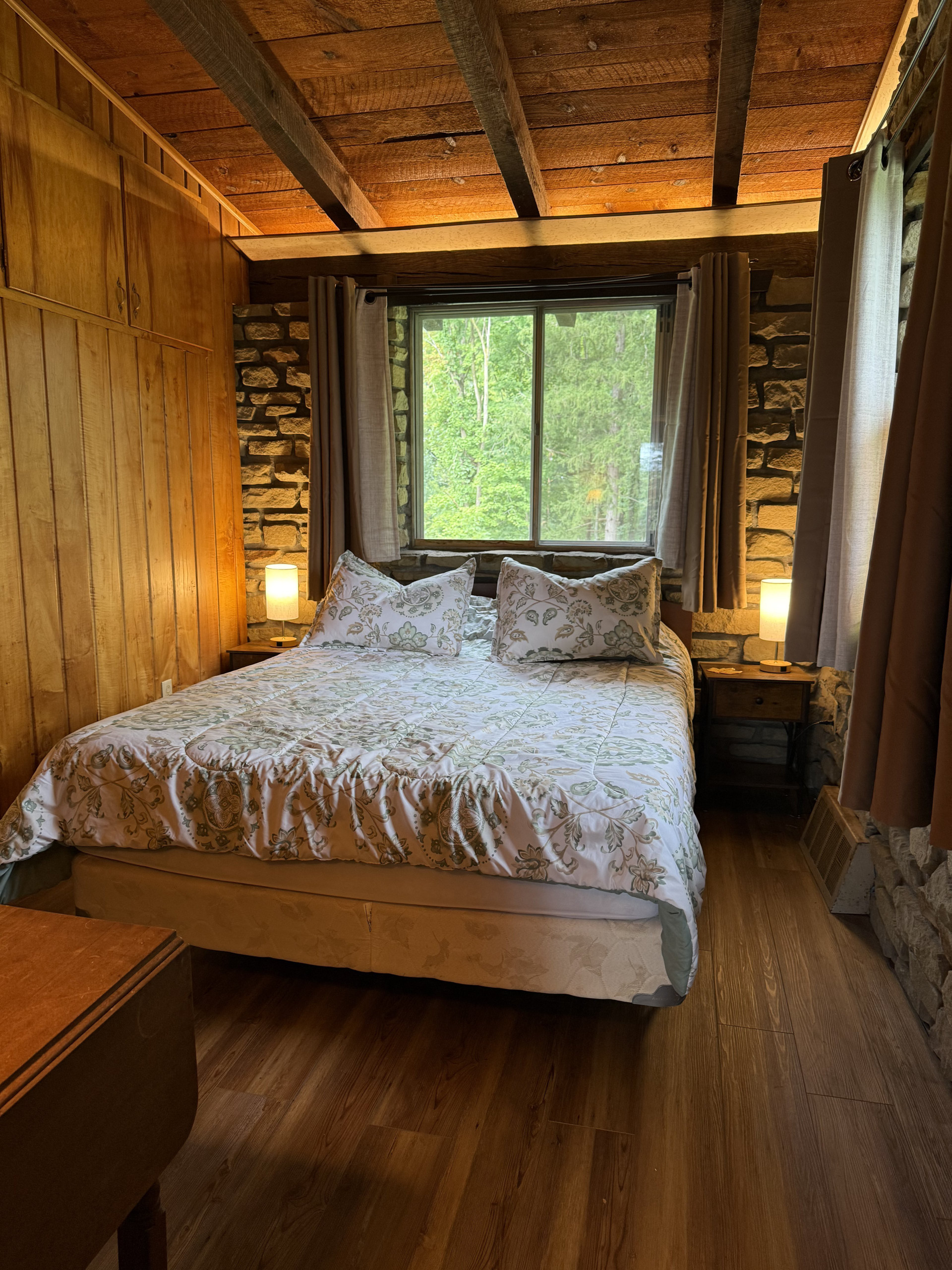 Rustic bedroom with lake view window