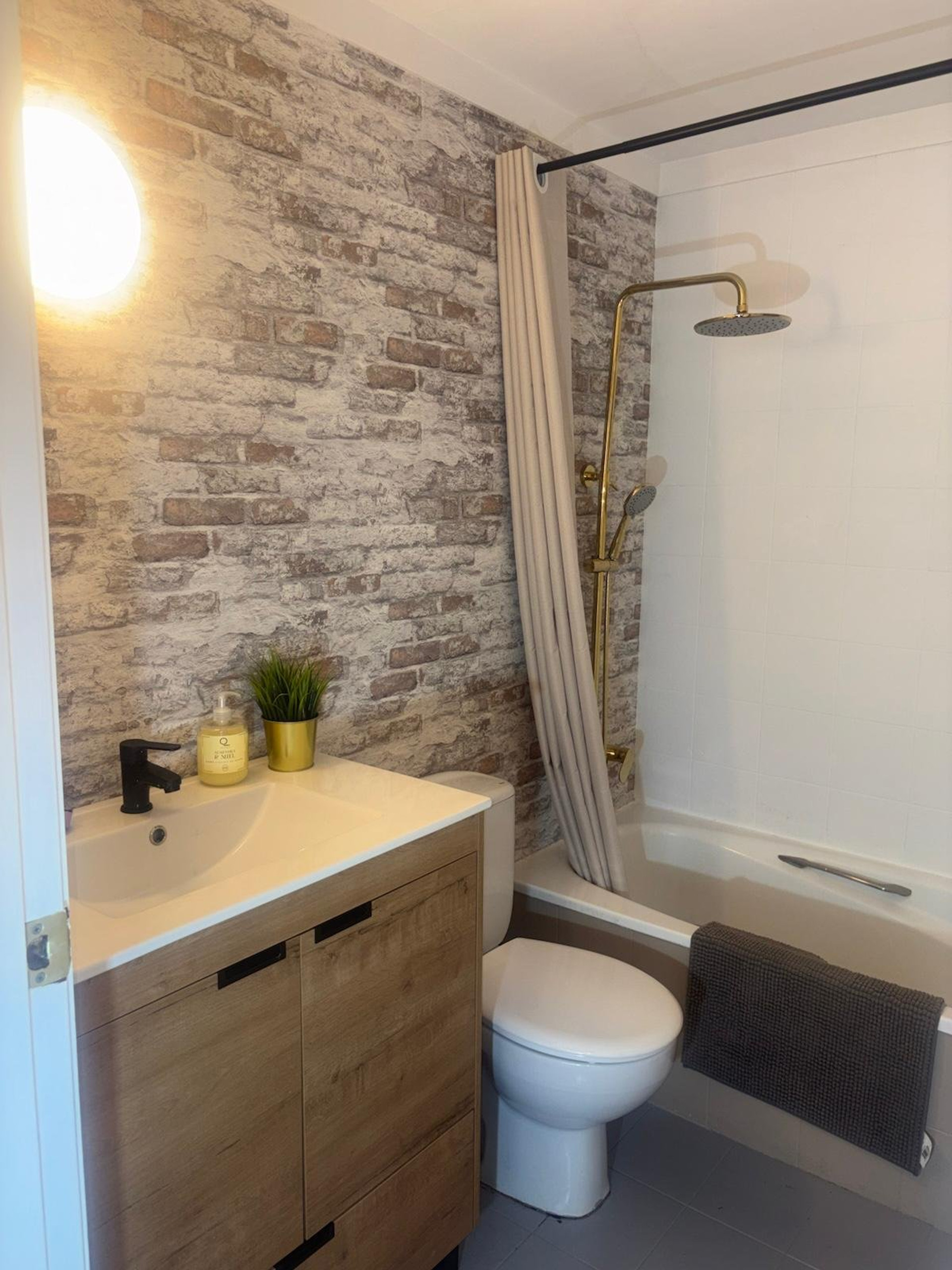 Bathroom with brick wall vanity