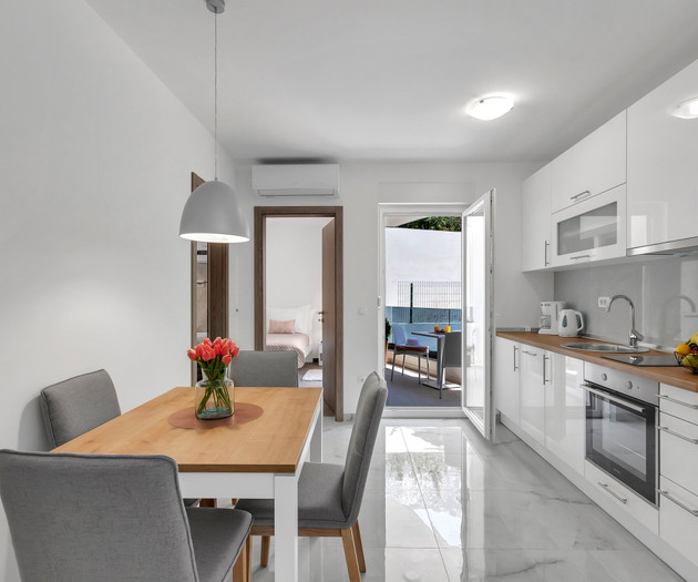 Kitchen with dining and balcony access