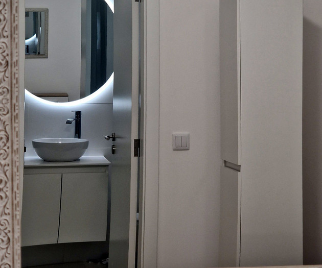 Mirror reflecting bathroom sink area