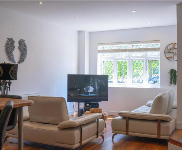 Bright living area with sofas and TV
