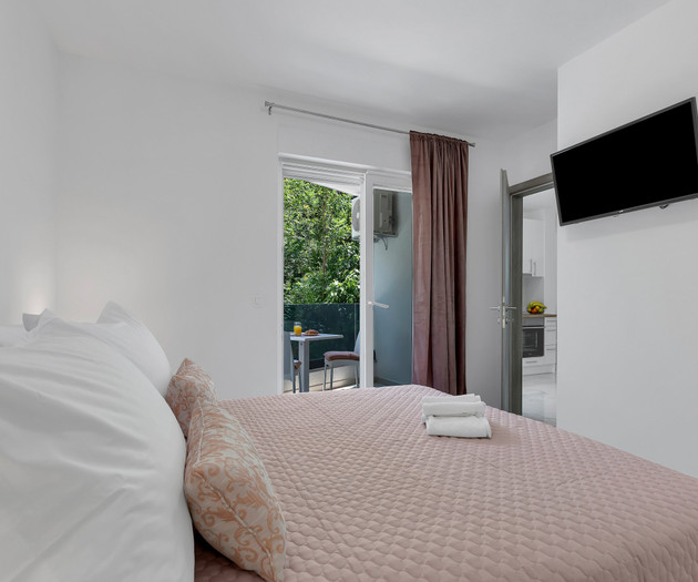 Bedroom with balcony and TV