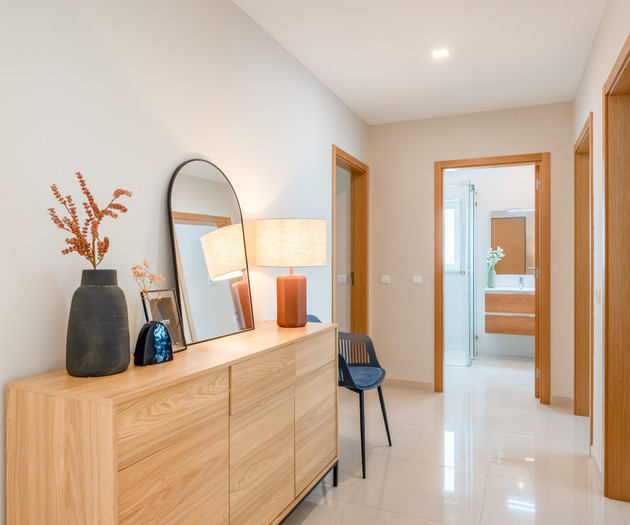 Hallway with dresser and mirror