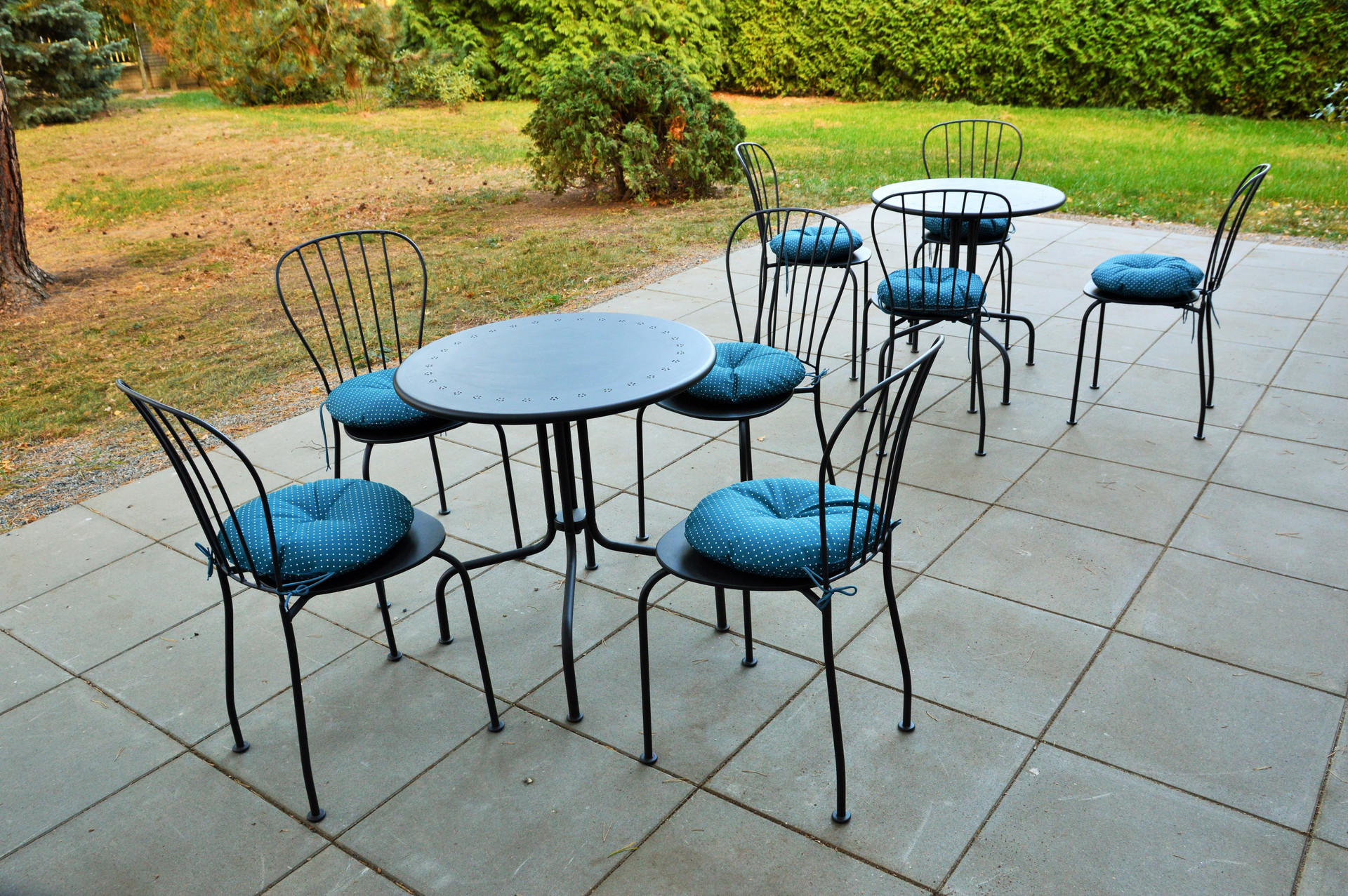 Patio with tables and cushioned chairs