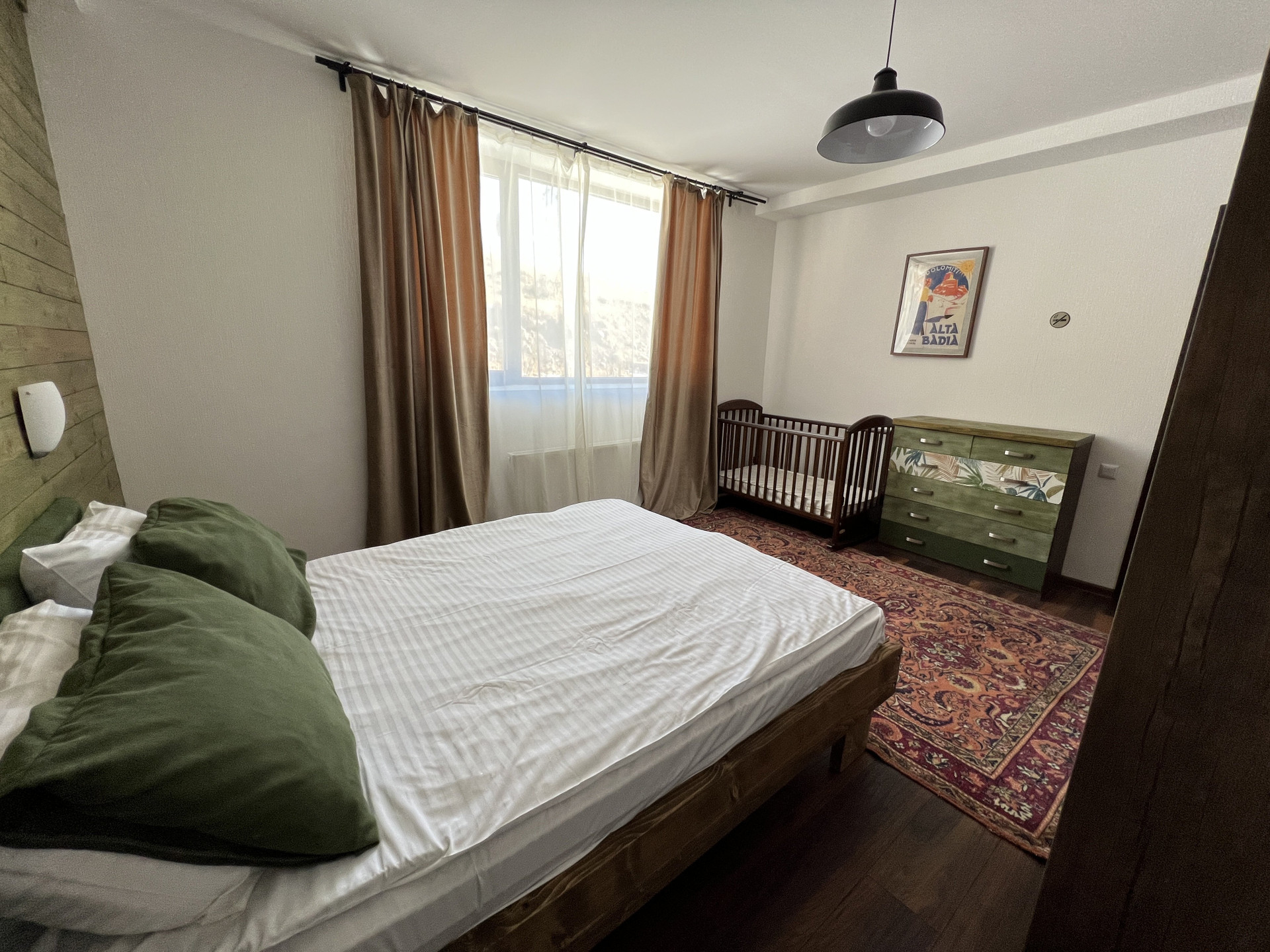 Bedroom with crib and dresser