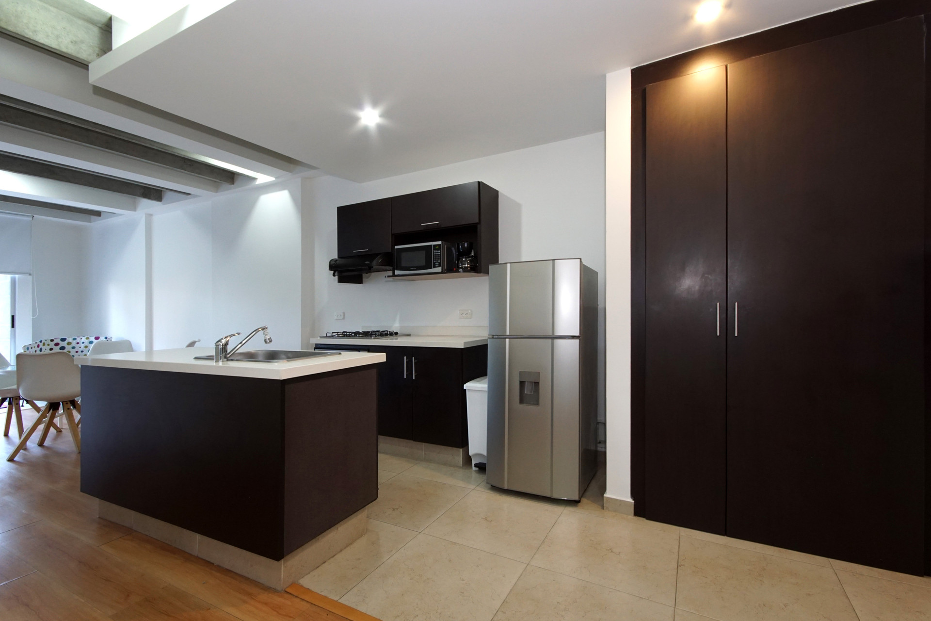 Kitchen with fridge and wardrobe