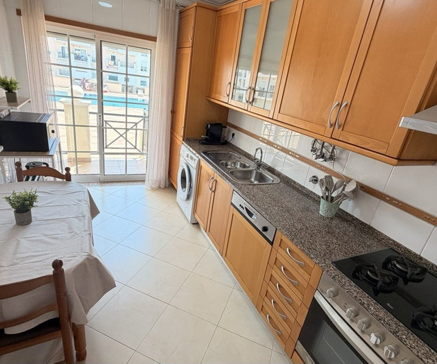 Kitchen with stove and pool view