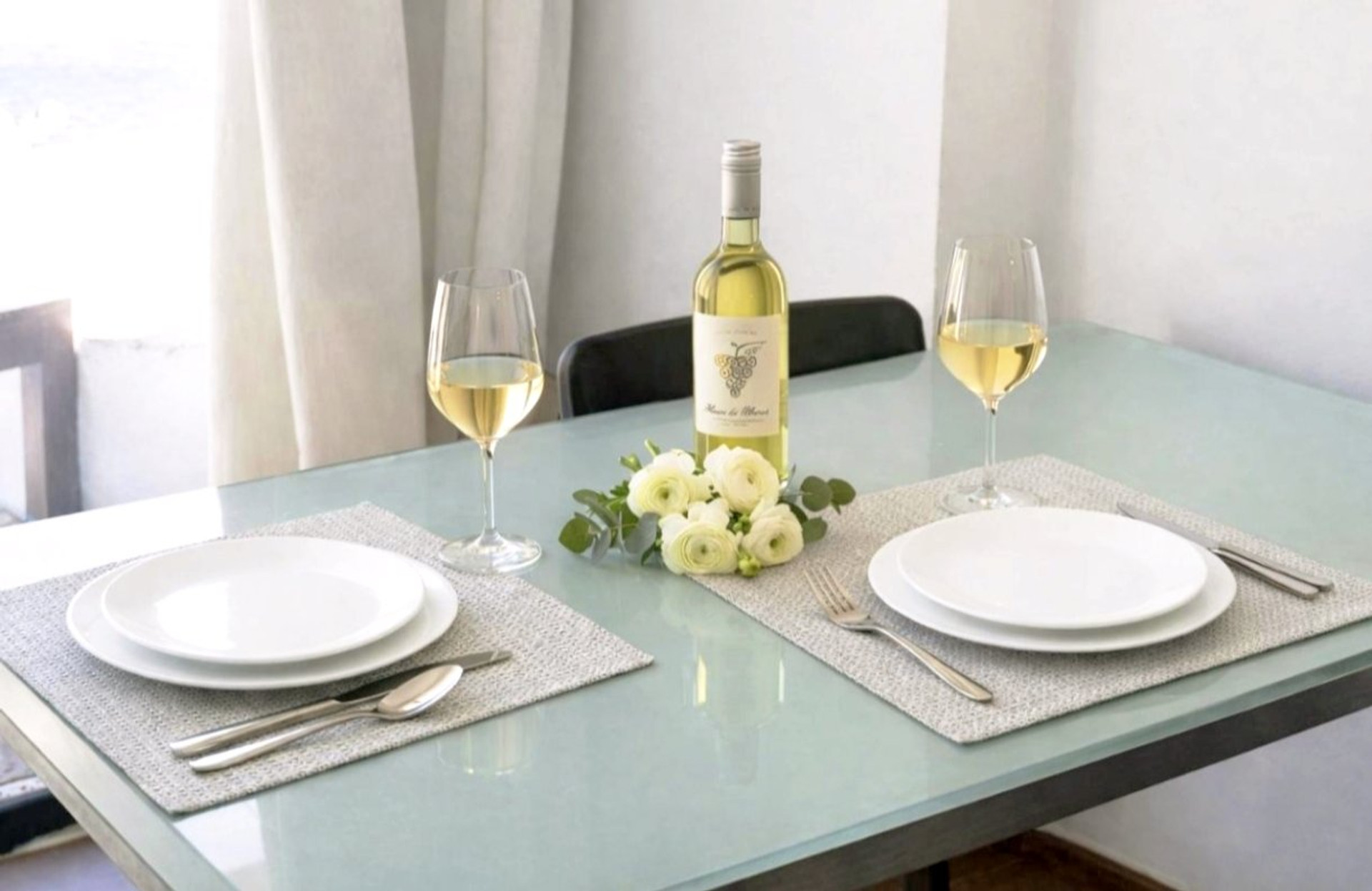 Dining table set for two with wine
