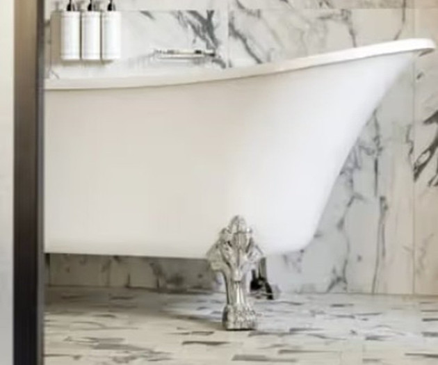 Freestanding bathtub with marble walls