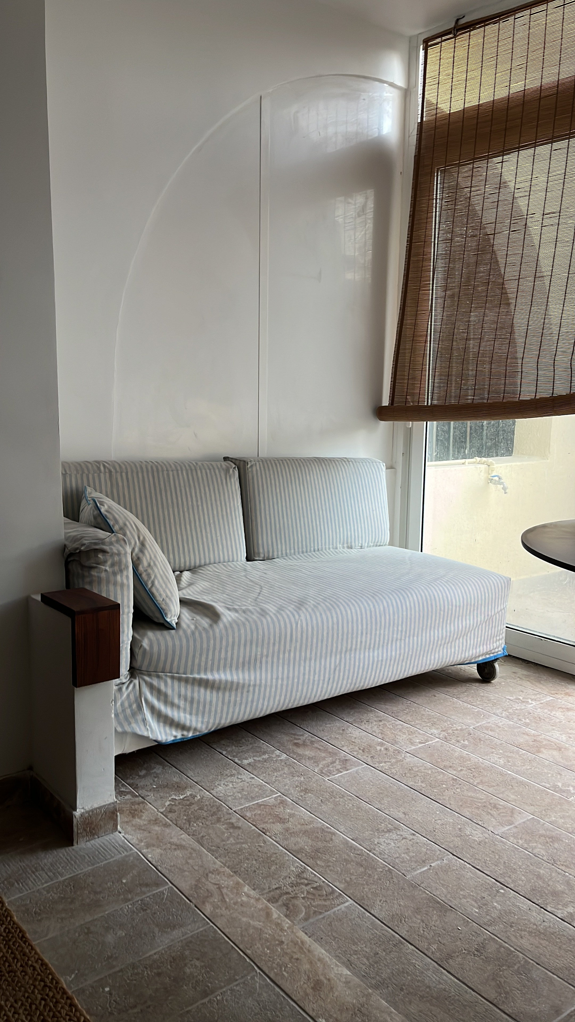 Sofa by window with bamboo blind