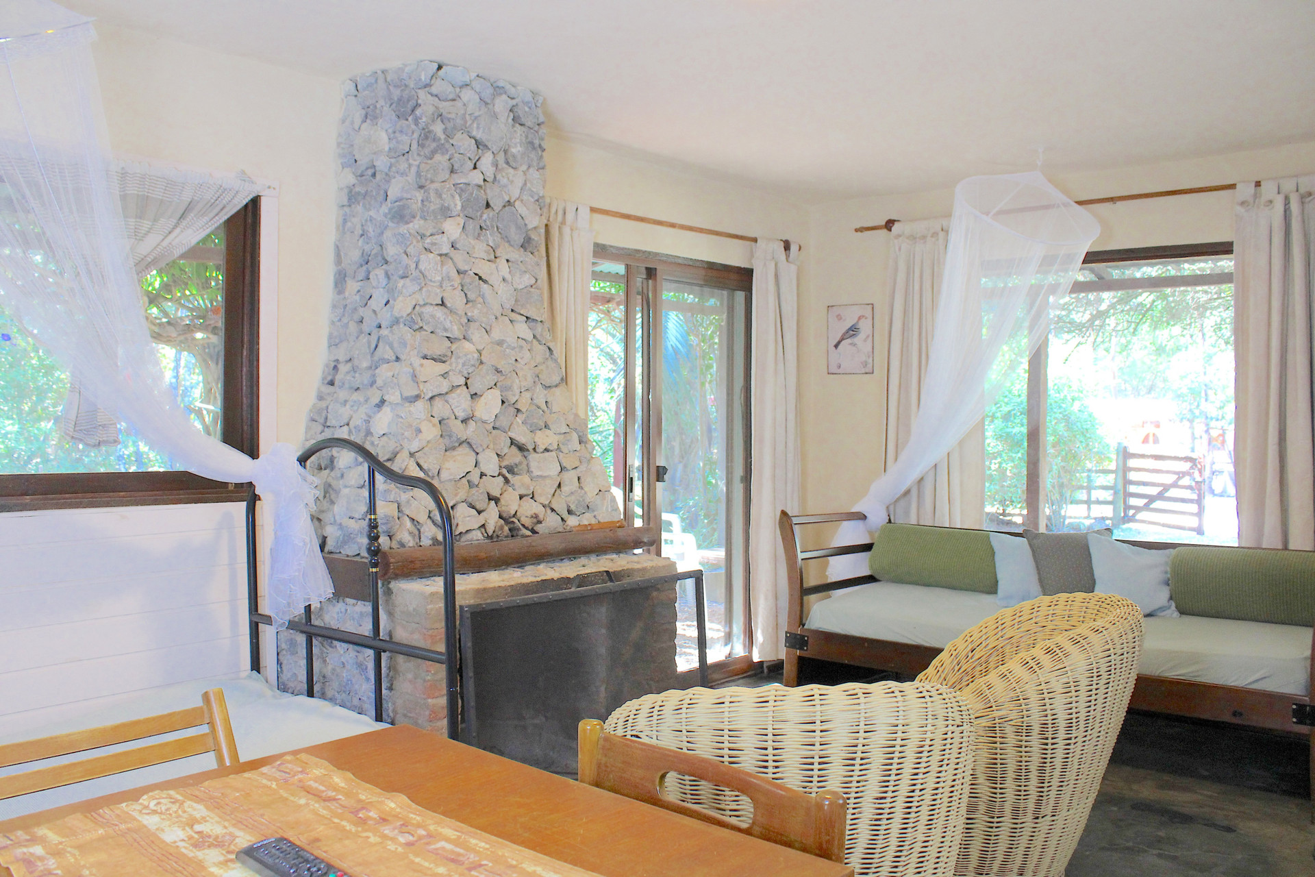 Living room with stone fireplace and seating, sofa bed & single bed