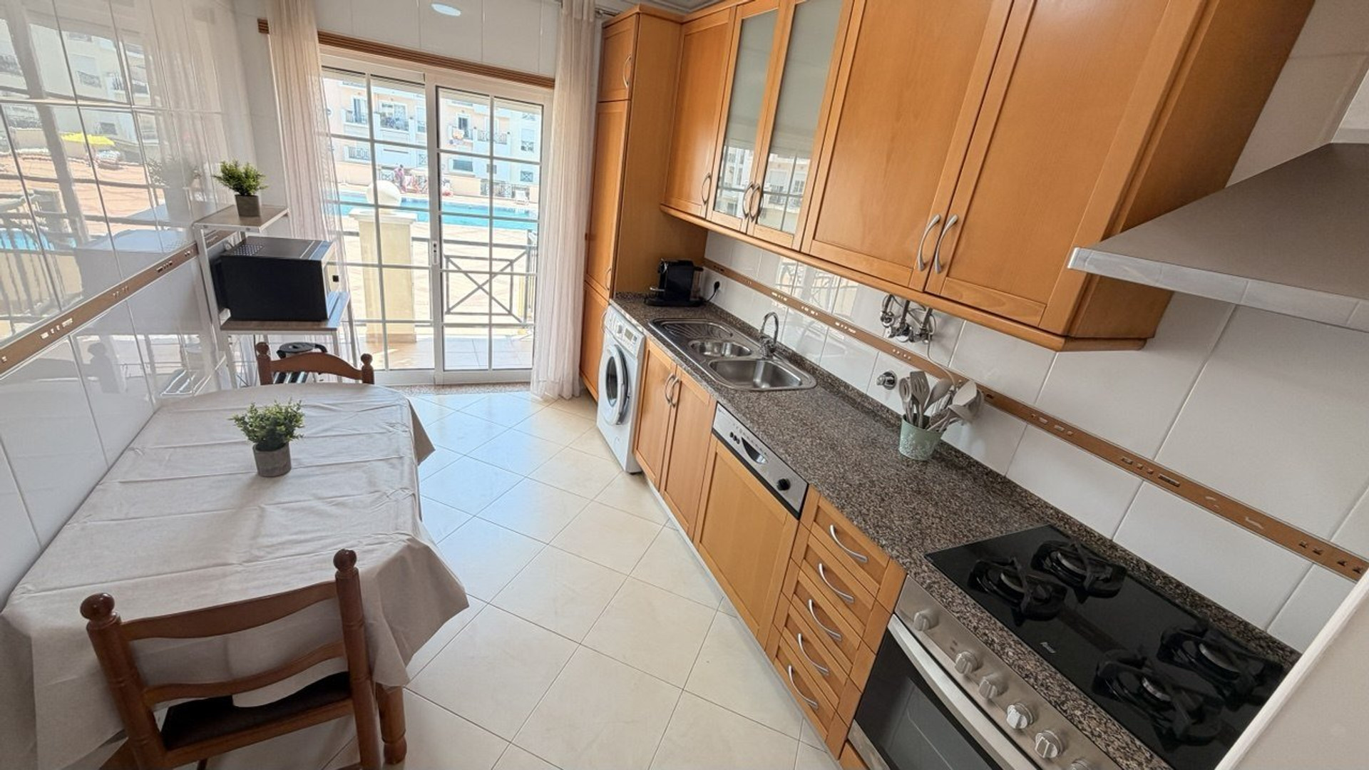 Kitchen with stove and pool view