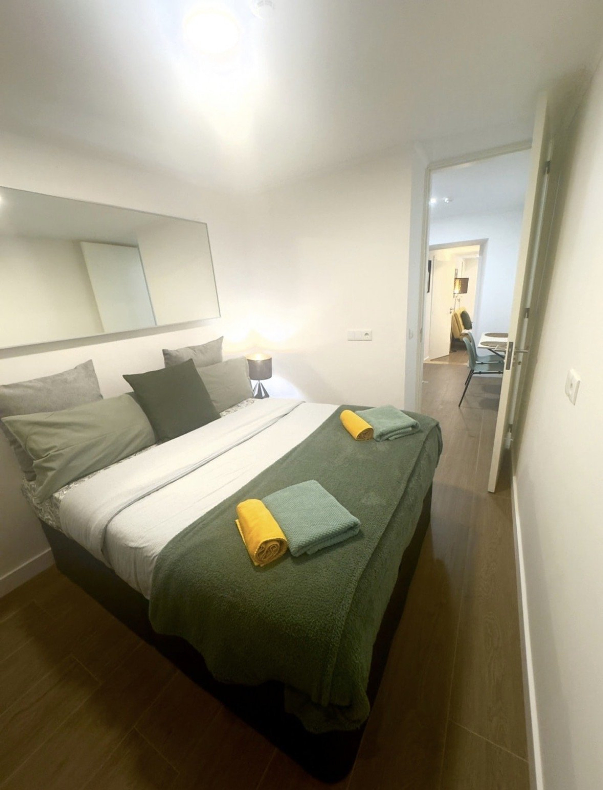 Bedroom with mirror and towels