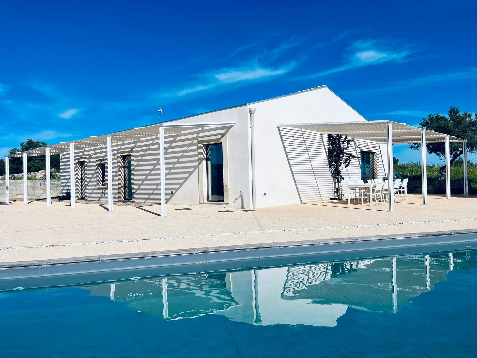 Villa exterior with pool reflection