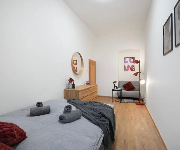 Bedroom with dresser and armchair