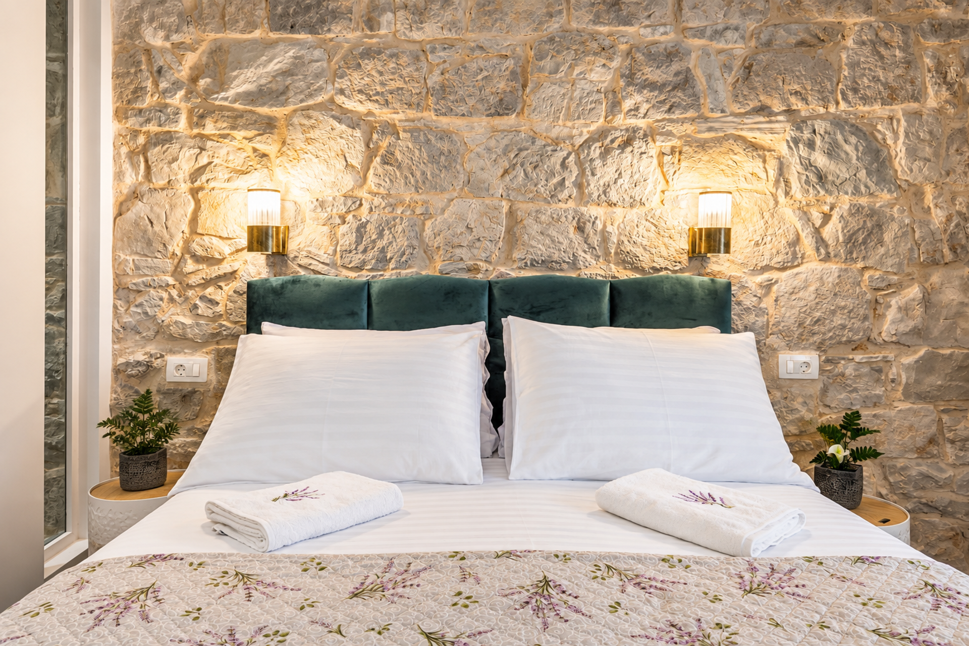 Bed close-up with stone wall