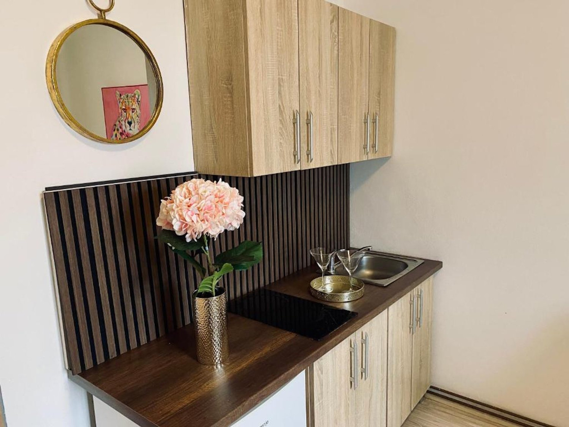 Kitchenette with cabinets and sink