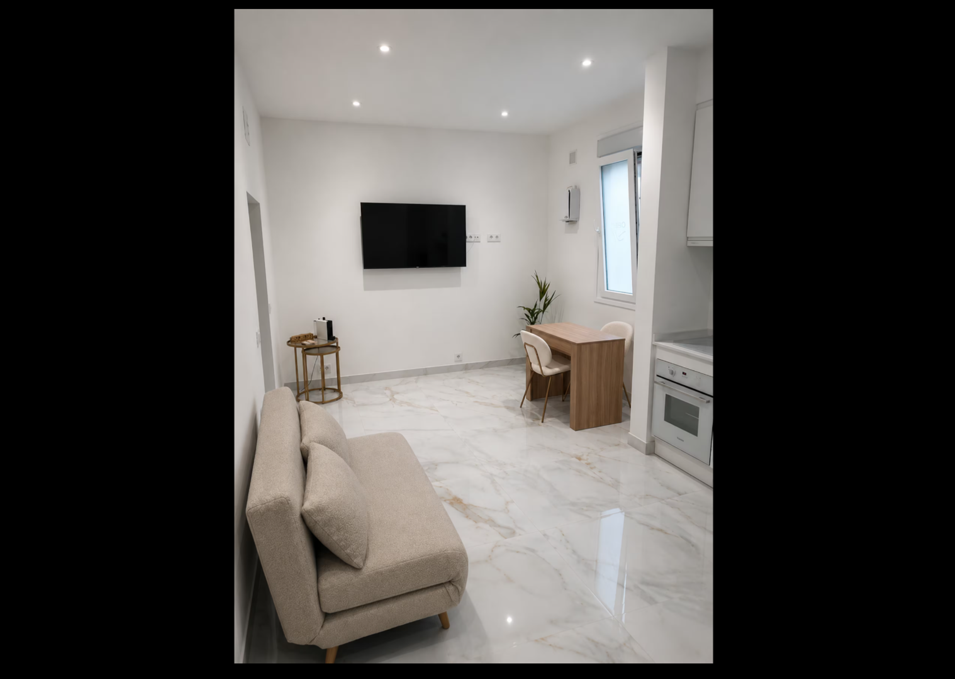 Bright living area with sofa and TV