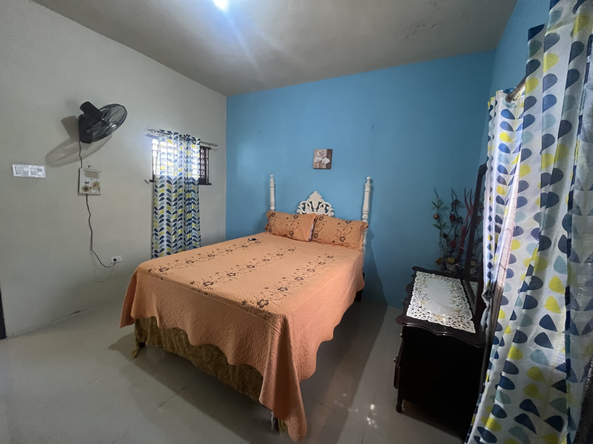 Bedroom with orange bedspread