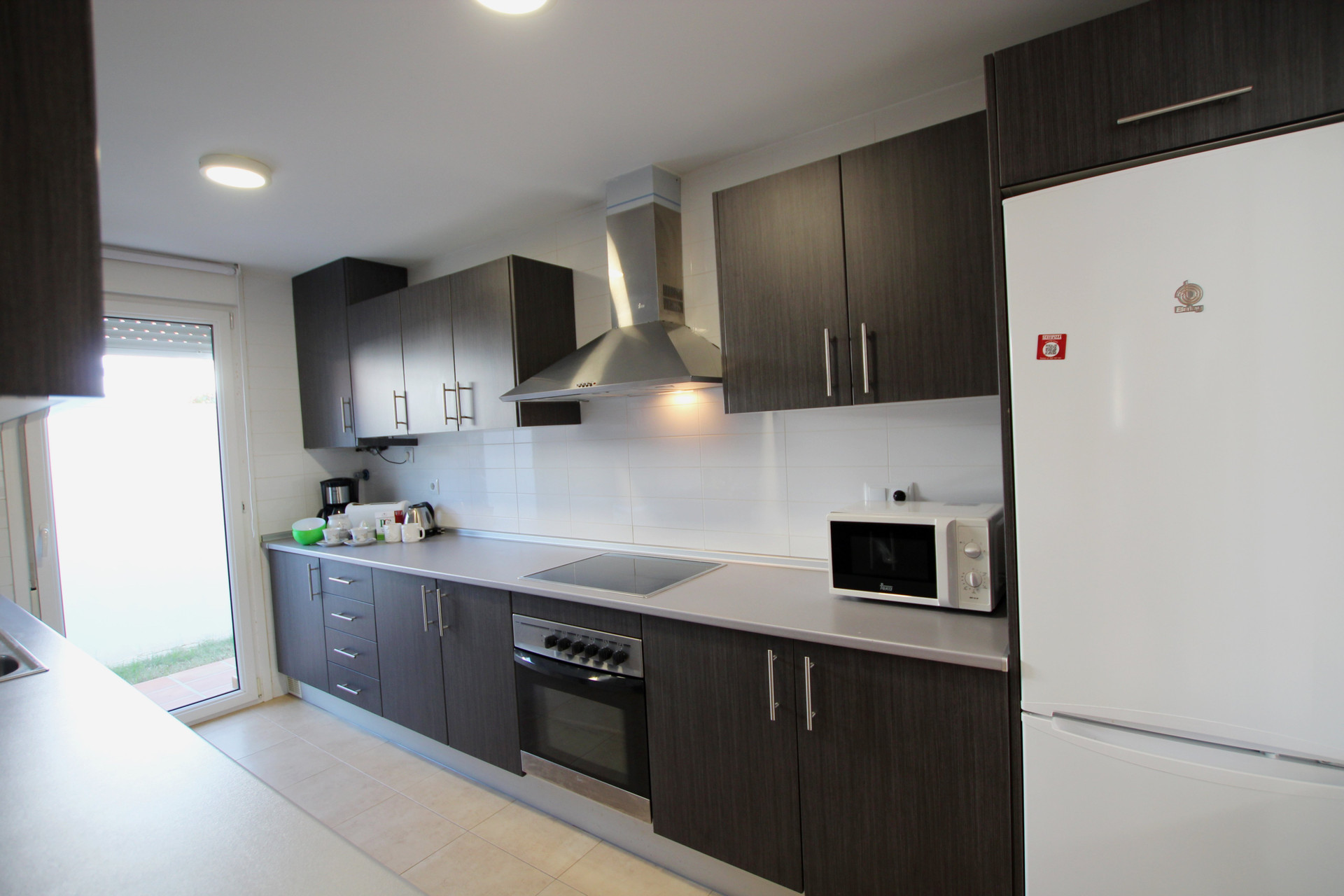 Modern kitchen with oven and fridge