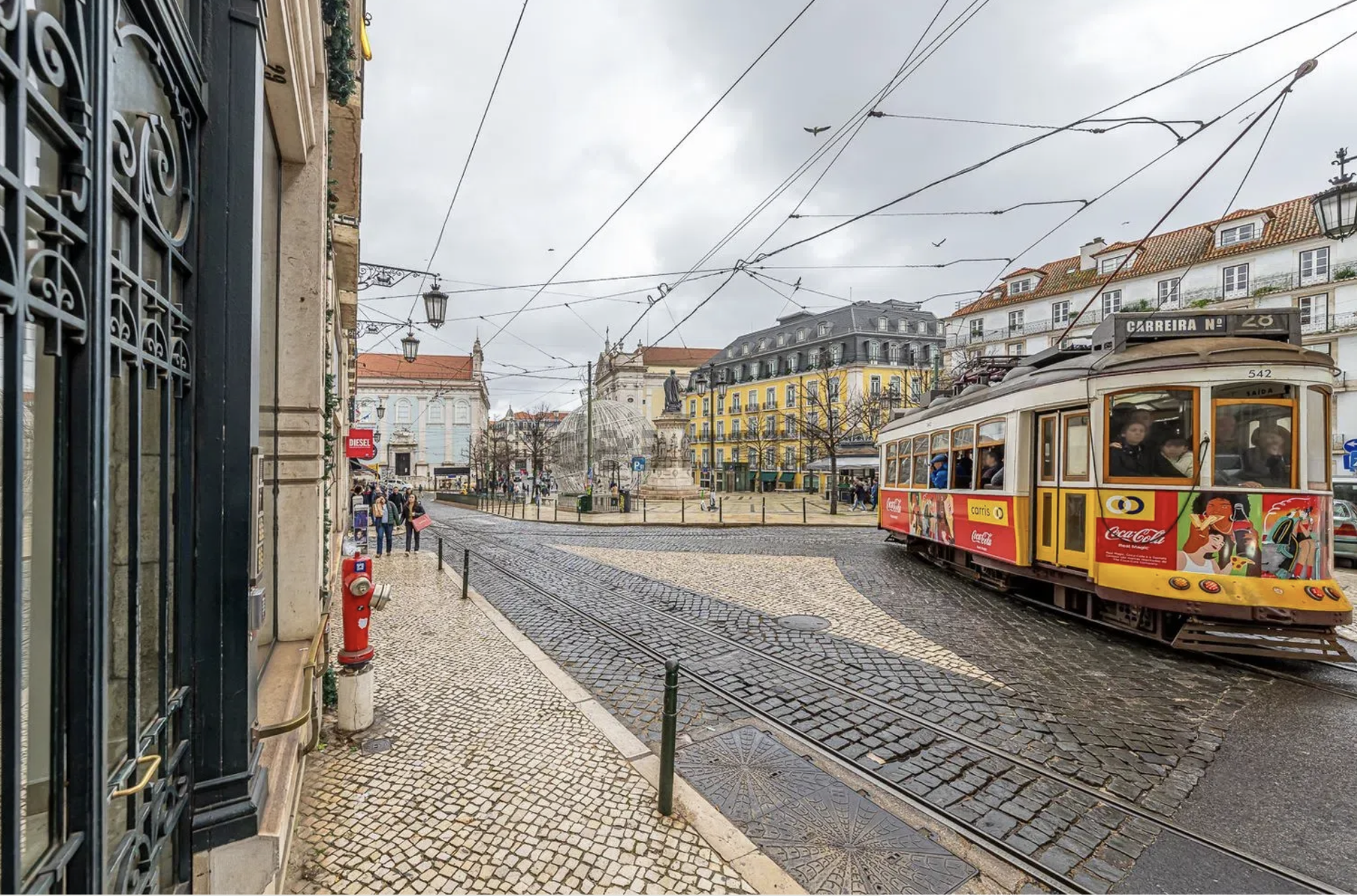 Street view with tram and monument