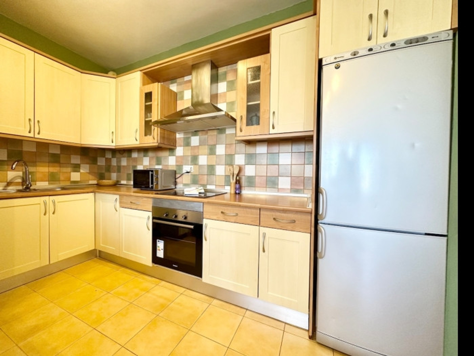 Full kitchen with oven fridge