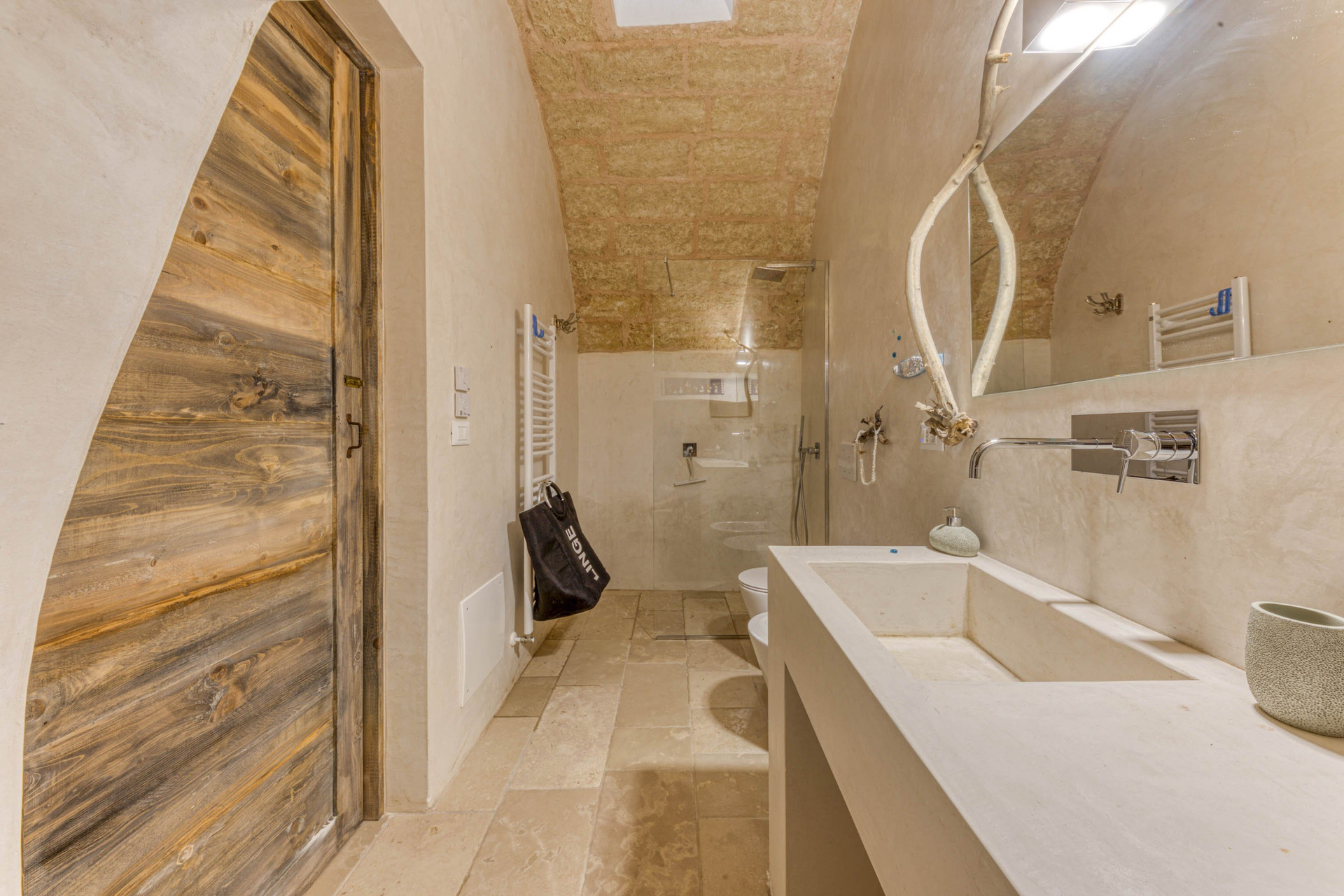 Bathroom with long sink and shower